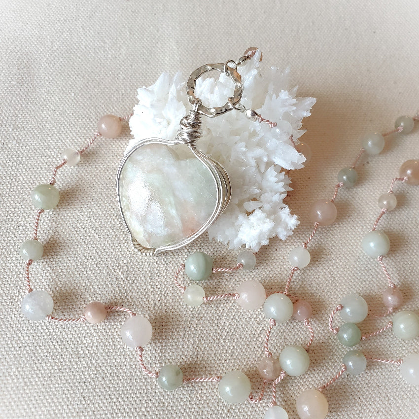 Necklace with a heart-shaped pendant on a beige background