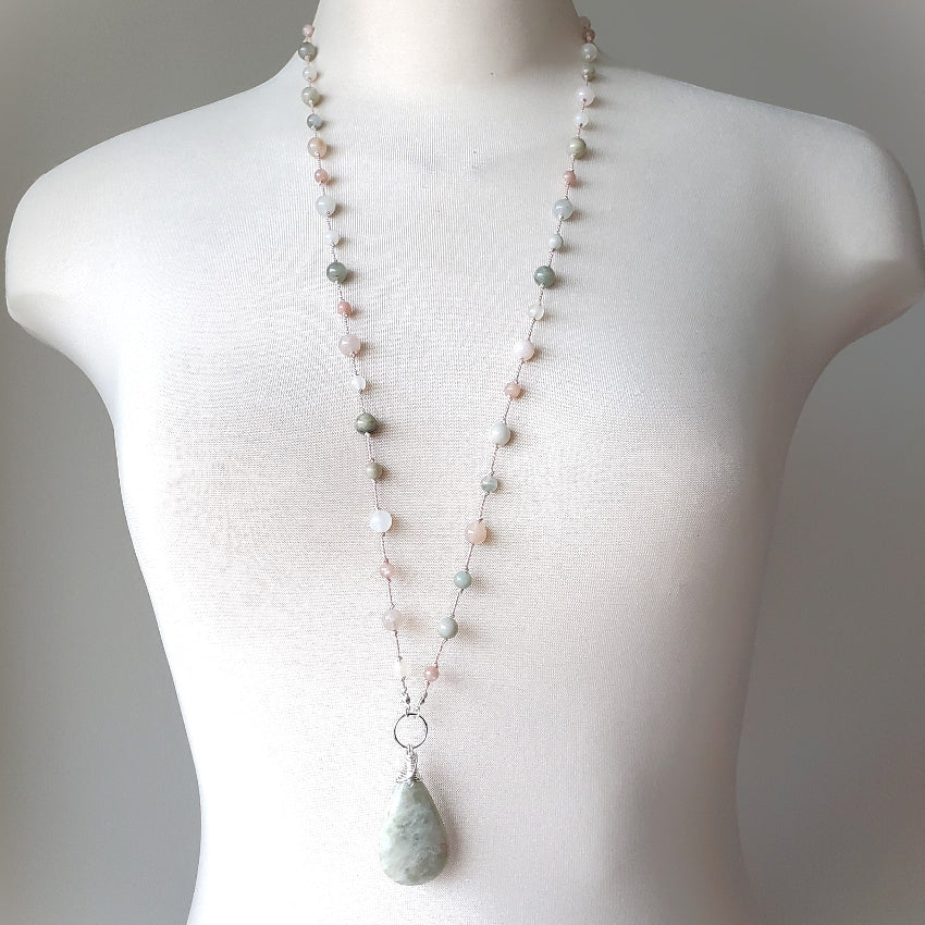 Necklace with a pendant on a mannequin against a neutral background