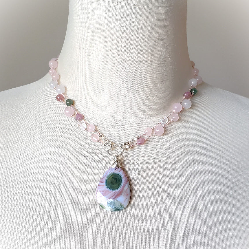 Pink and green gemstone knotted necklace on bust 