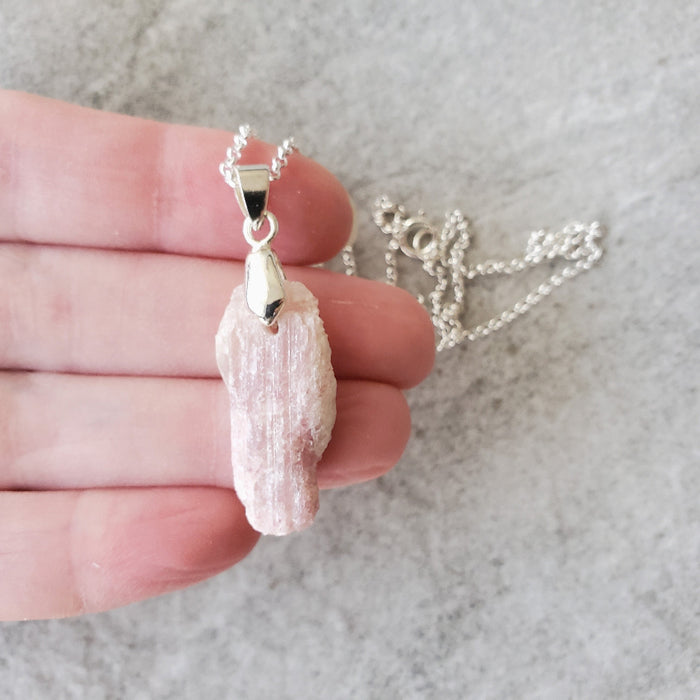 Pink Tourmaline nugget pendant necklace in hand