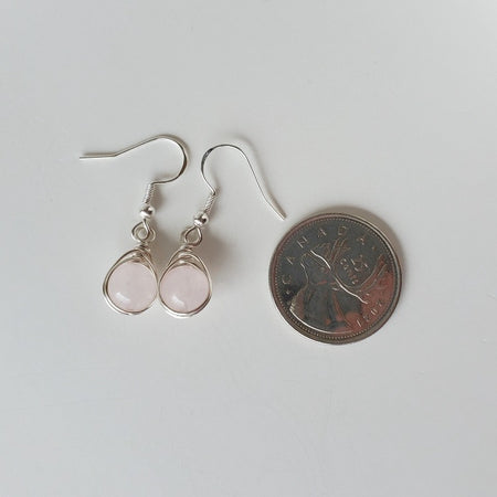 Rose Quartz herringbone wrapped silver earrings beside a quarter