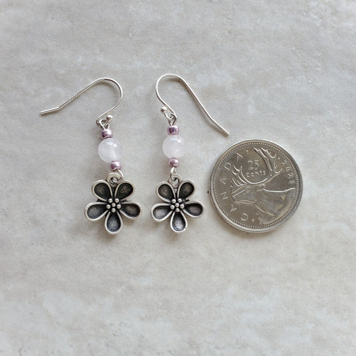 Rose Quartz Flower charm earrings beside a quarter