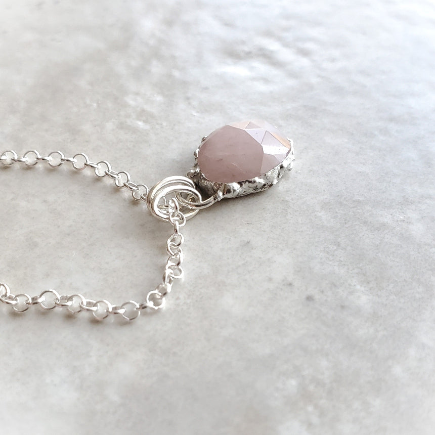 Rose Quartz pendant necklace on tile