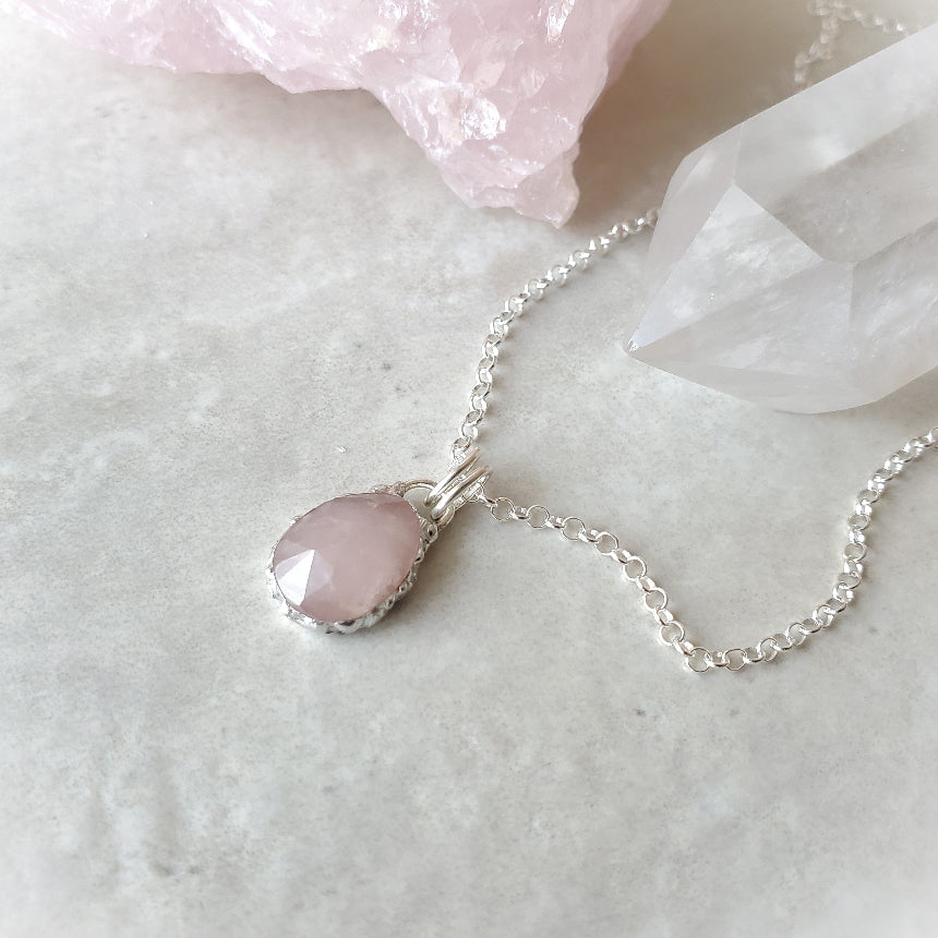 Rose Quartz pendant necklace on tile