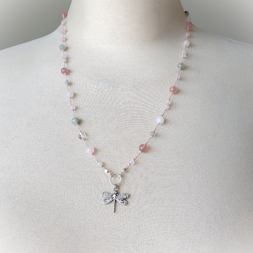 Knotted gemstone necklace with dragonfly focal on a bust