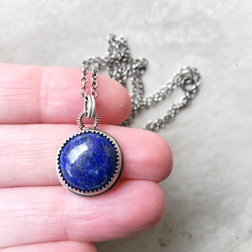 Lapis Lazuli silversmith pendant necklace in hand