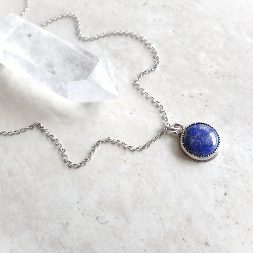 Lapis Lazuli silversmith pendant necklace on tile 