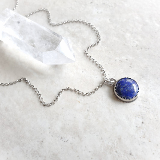 Lapis Lazuli silversmith pendant necklace on tile 