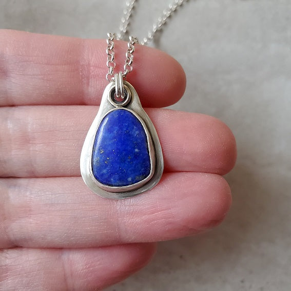 Freeform Lapis Lazuli Metalsmith Necklace in hand