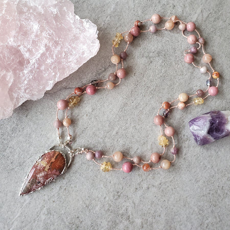 Crazy Lace Agate multi gemstone knotted necklace doubled on tile