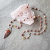 Crazy Lace Agate multi gemstone knotted necklace single strand on tile