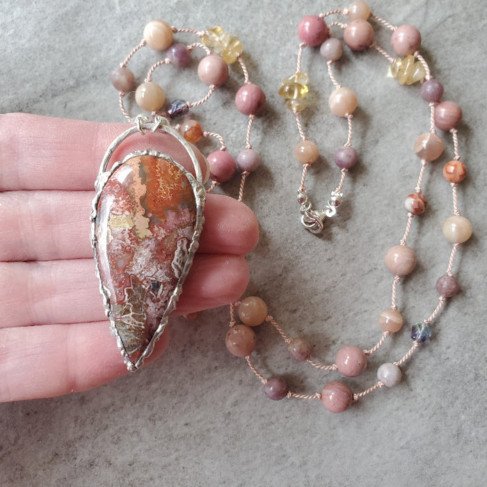 Crazy Lace Agate multi gemstone knotted necklace in hand