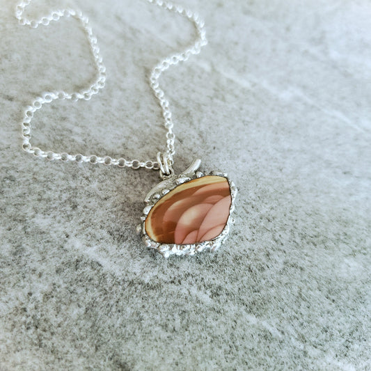 Imperial Jasper soft solder style pendant on a textured surface