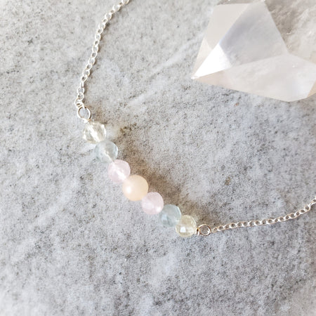 Multi gemstone bar sterling silver necklace on tile