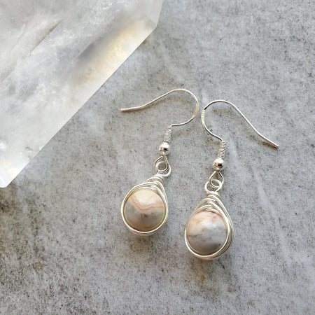 Crazy lace Agate herringbone wrap sterling silver earrings on tile 
