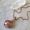Polychrome Jasper wire wrapped heart pendant on tile