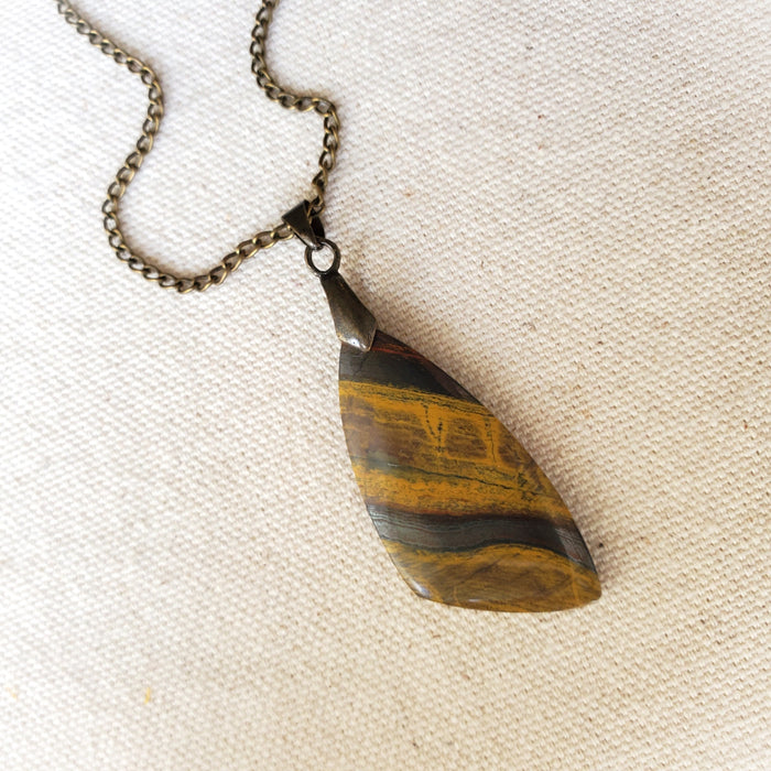 Freeform Tigers eye pendant necklace on linen