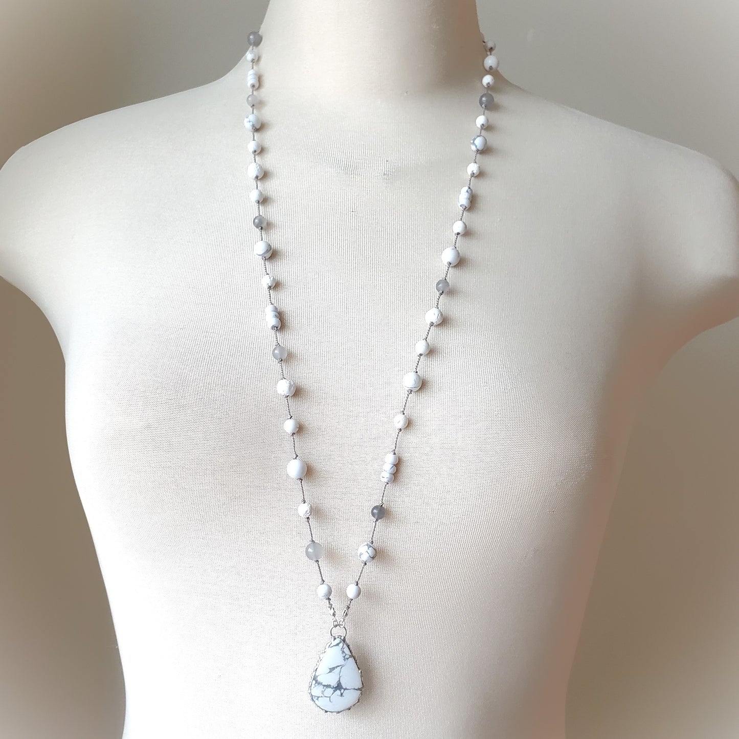 Necklace with a teardrop-shaped pendant on a mannequin