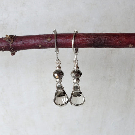 Smoky quartz briolette earrings hanging on a branch