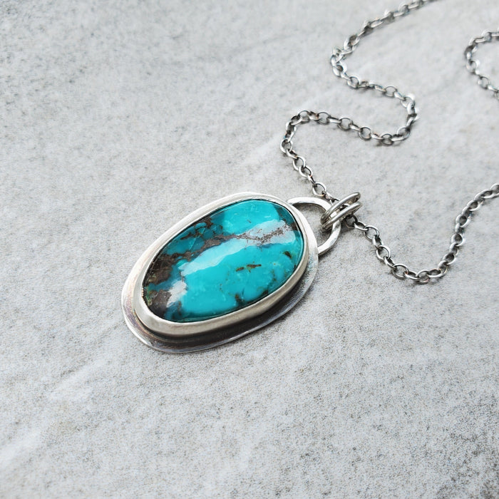 Tibetan Turquoise freeform bezel set necklace on tile