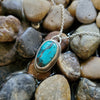 Freeform Tibetan turquoise bezel set necklace on rocks