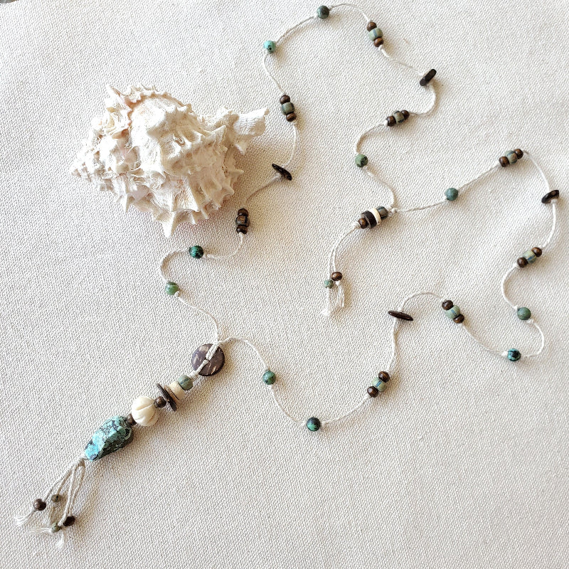 Beaded necklace with natural stones on a light background