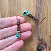 wire wrapped copper earrings with natural turquoise in hand