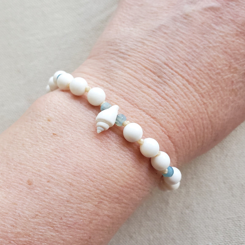 white shell knotted bracelet on model 