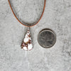 Wild Horse magnesite necklace beside a quarter