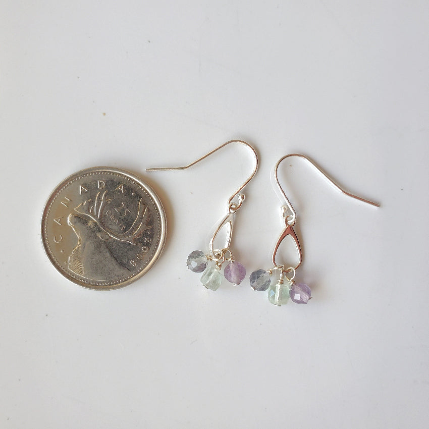 Faceted Fluorite dangle silver earrings beside a quarter