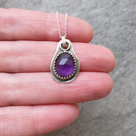 Faceted Amethyst silversmith necklace in hand