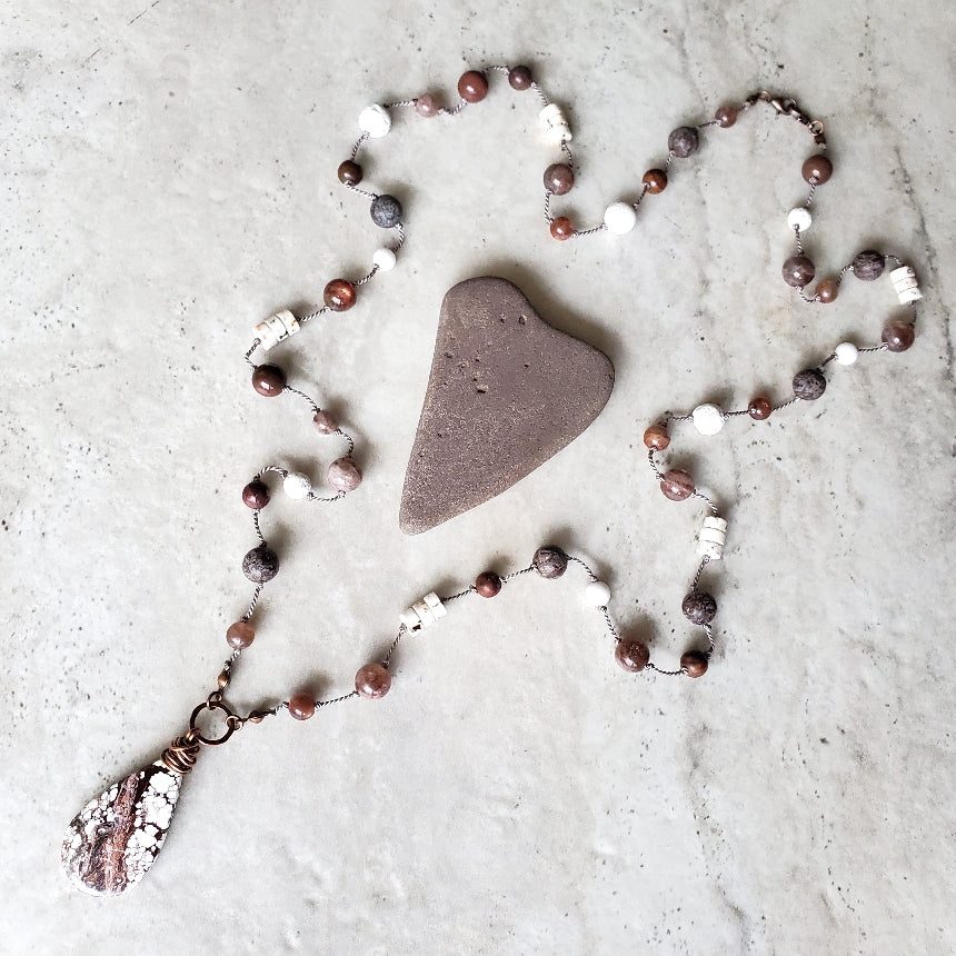 Multi gemstone knotted necklace on tile 