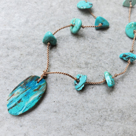 Hand knotted silk necklace with floating Turquoise chips and a Blue Opal focal stone. 