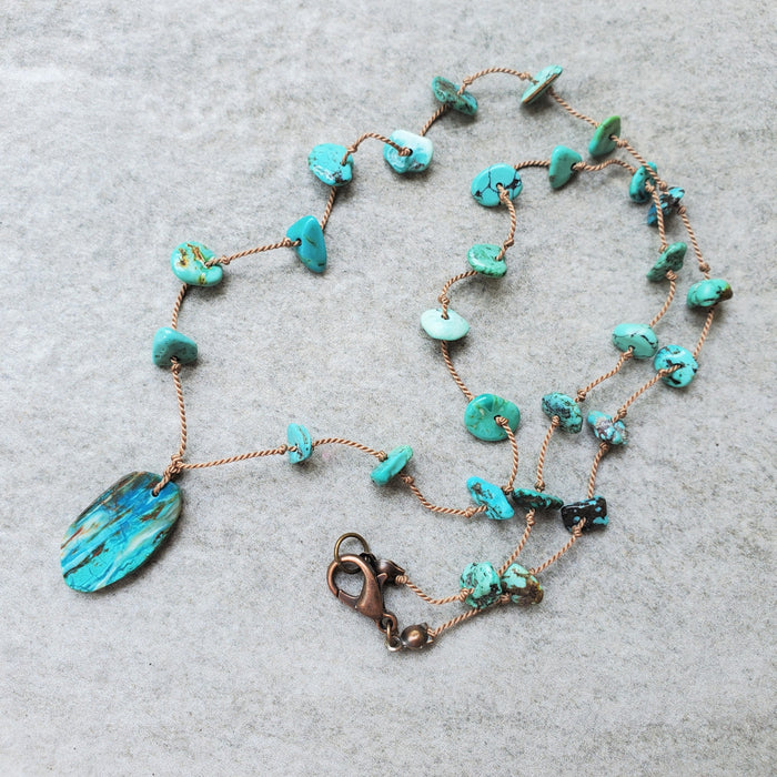 Hand knotted silk necklace with floating Turquoise chips and a Blue Opal focal stone. 