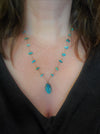 Hand knotted silk necklace with floating Turquoise chips and a Blue Opal focal stone. 