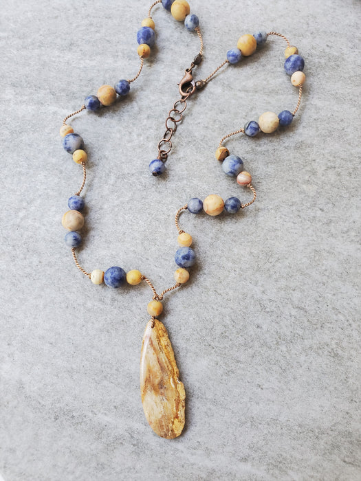 Silk Knotted Necklace with Crazy Lace Age, Sodalite beads and a Fossil Coral Focal.