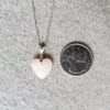 Pink Opal heart pendant hanging on a sterling silver chain