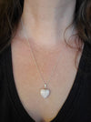 Model wearing a Pink Opal heart pendant hanging on a sterling silver chain