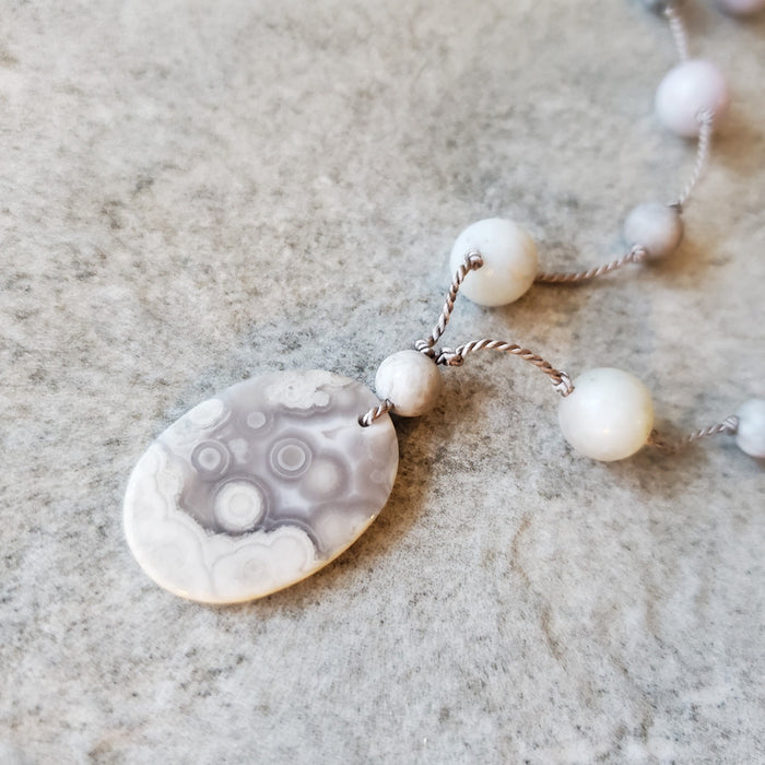 Hand knotted silk necklace featuring a purple lace agate focal  stone and beads