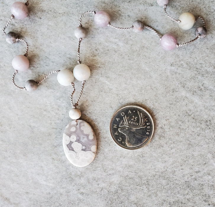 Hand knotted silk necklace featuring a purple lace agate focal  stone and beads