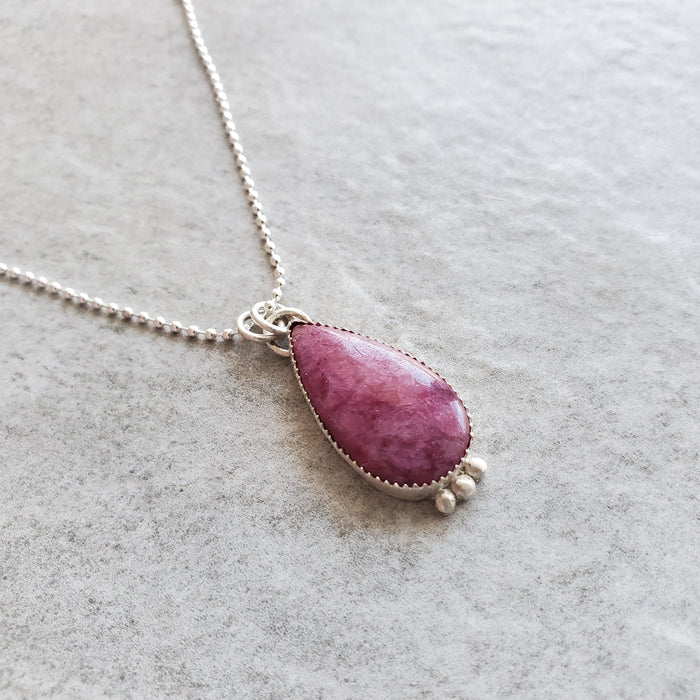 Silversmith pendant featuring a ruby zoisite gemstone and sterling silver setting. 