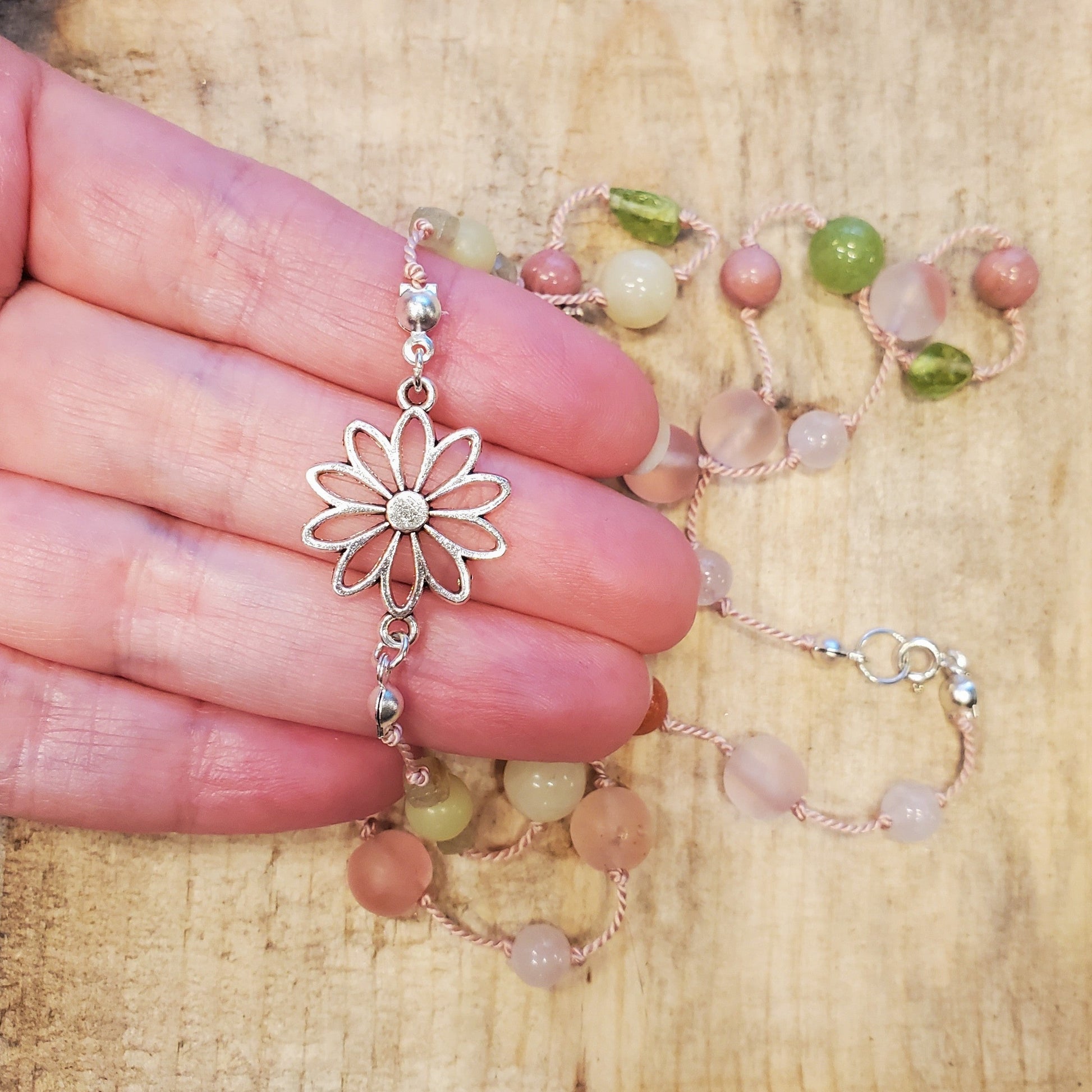 Colourful silk knotted necklace with multi gemstones and a flower connector. 