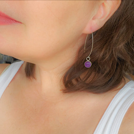 Amethyst stones bezel set in sterling silver and hanging from sterling silver ear wires. 
