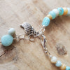 Detail of Gemstone charm Bracelet with shell and amazonite